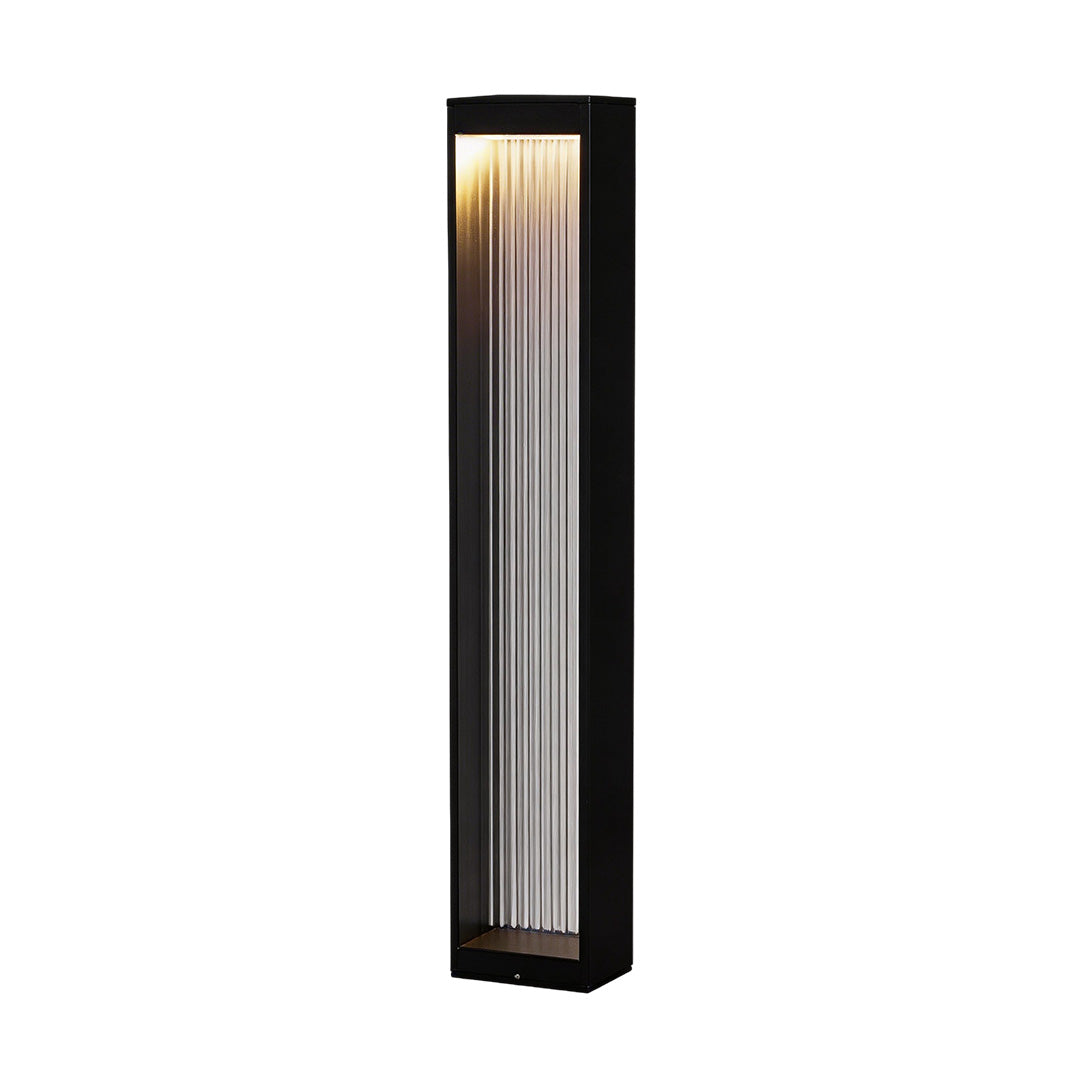Bollard garden lights with a modern design, enhancing a landscaped garden.