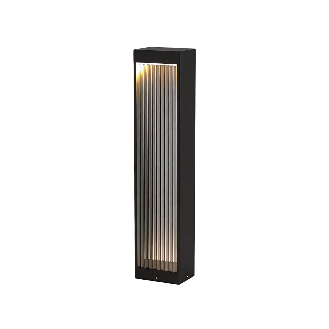 Bollard garden lights with a sleek design, illuminating a garden pathway.