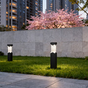 Bollard landscape light installed near a pool area, offering a stylish and functional lighting solution.