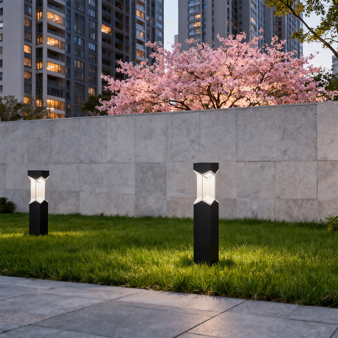 Bollard landscape light installed near a pool area, offering a stylish and functional lighting solution.