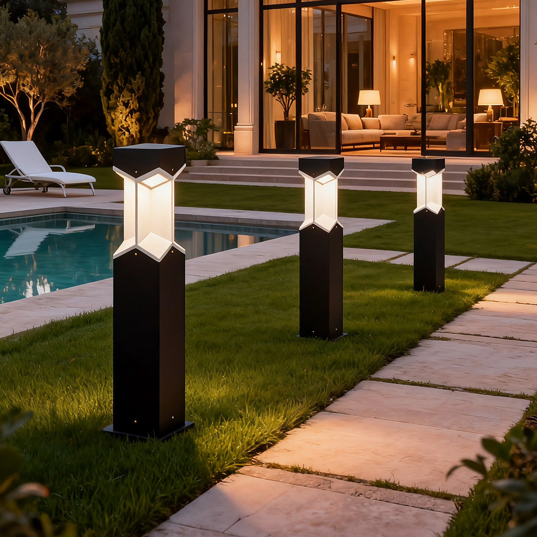 Bollard landscape light installed near a pool area, offering a stylish and functional lighting solution.