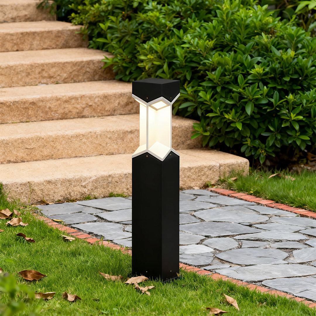 Bollard landscape light placed near stone steps, enhancing the outdoor space with subtle lighting.