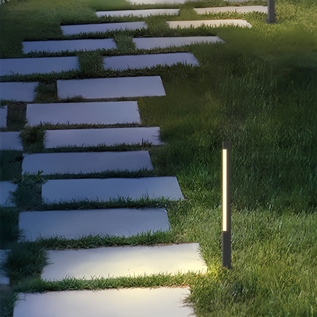 Modern bollard landscape lighting arranged along stone garden steps for safe and stylish nighttime navigation.