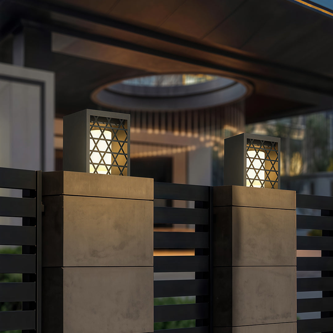 Bollard light fixtures with intricate patterns, designed to enhance the beauty of the garden with soft illumination.