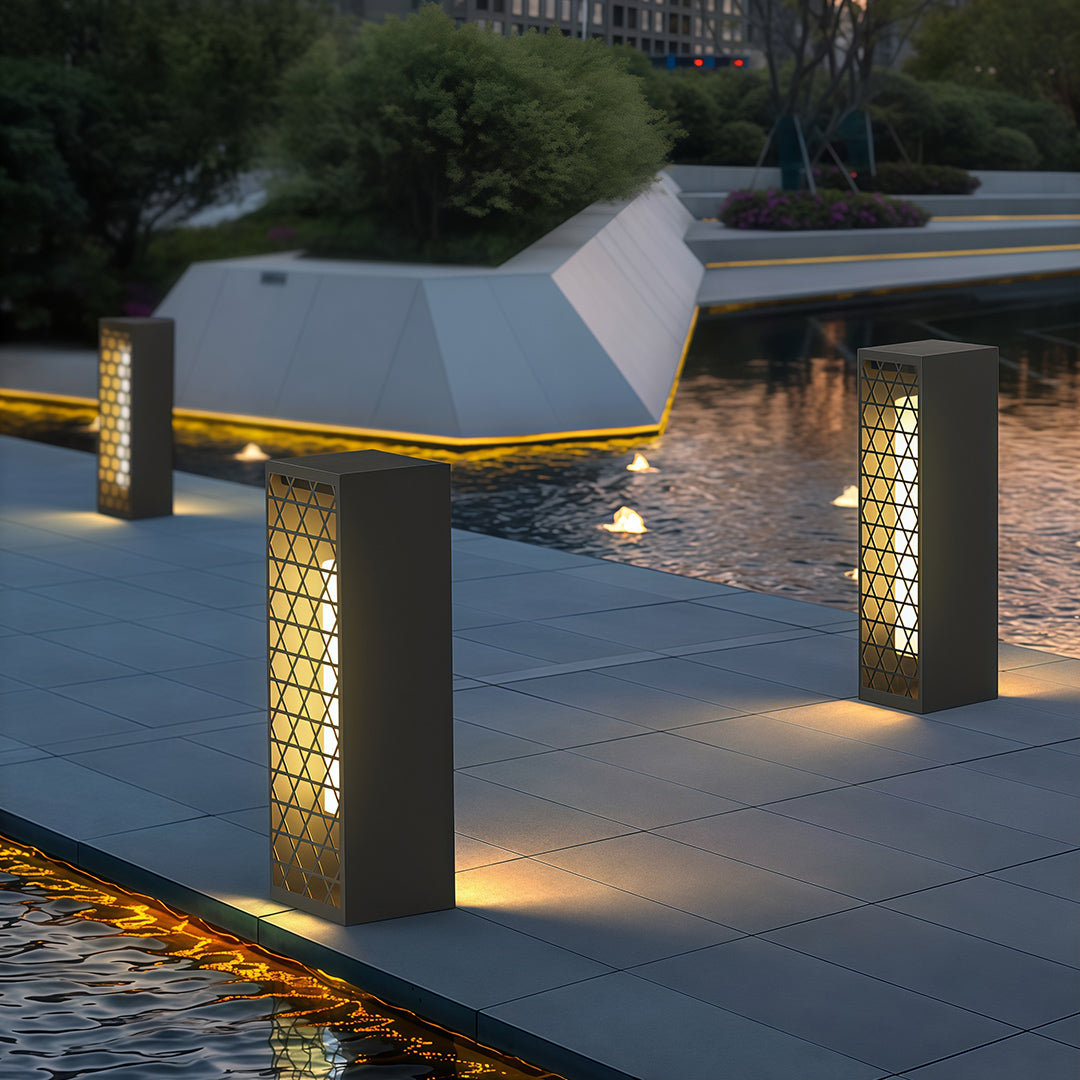 Bollard landscape lights along a pool area, creating a tranquil atmosphere with gentle lighting.
