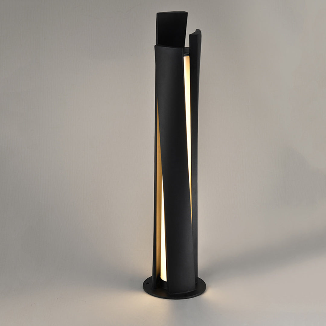 Close-up of bollard lighting fixtures showing black finish and vertical light strip detail on concrete surface
