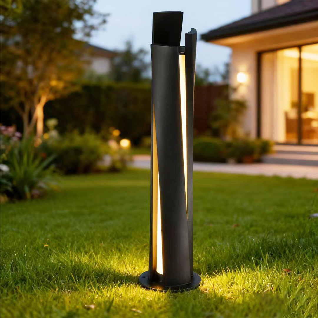 Bollard lighting fixtures illuminating residential garden at dusk with warm downward glow along pathway