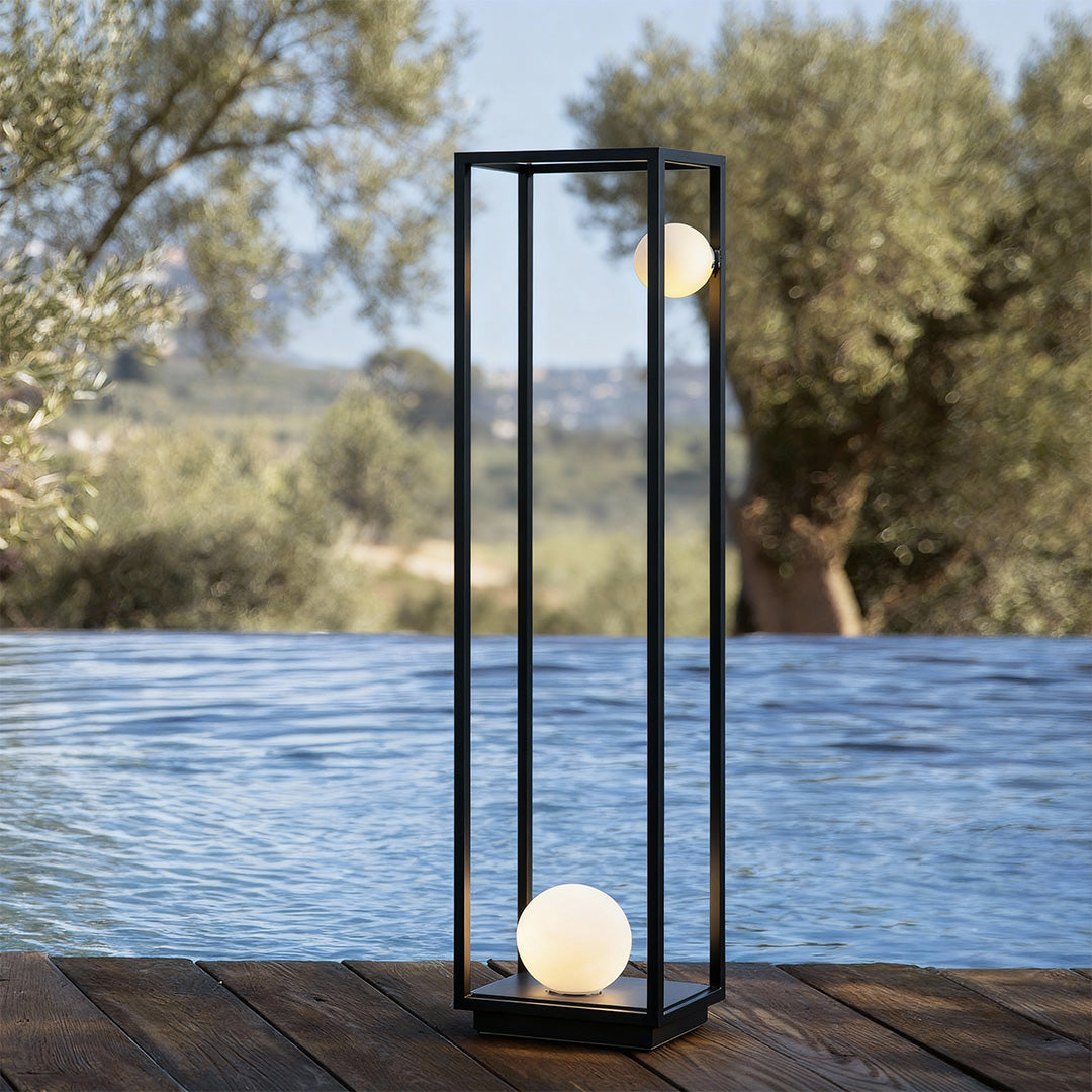 Bollard outdoor lighting placed beside natural greenery, adding a sleek, minimalist touch to the landscape.