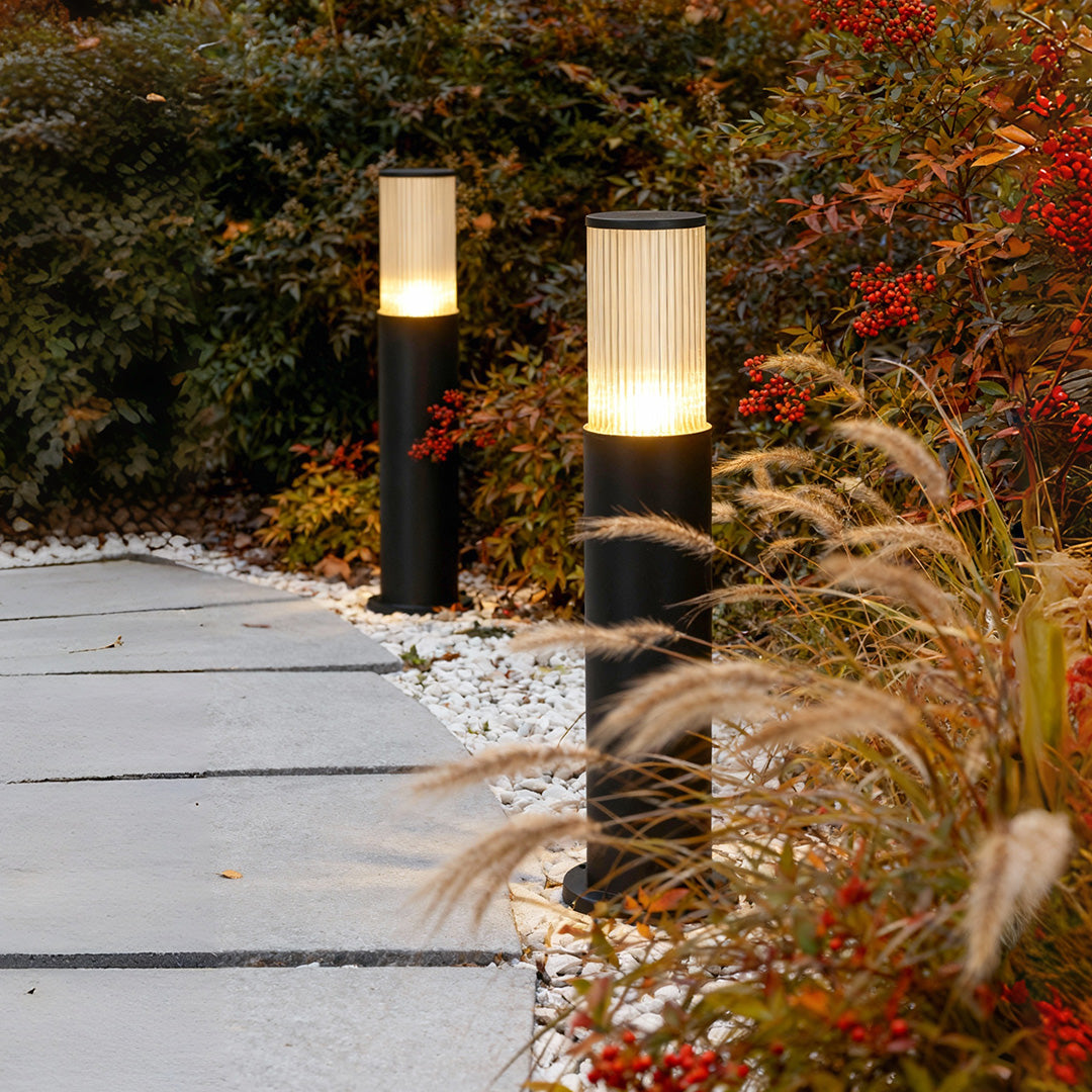 Bollard path light with ribbed glass lantern offers soft, glare-free illumination to enhance safety and elegance along outdoor walkways.
