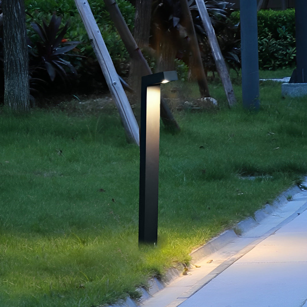Bollard path light along a sidewalk, providing safety and elegance to the outdoor space.