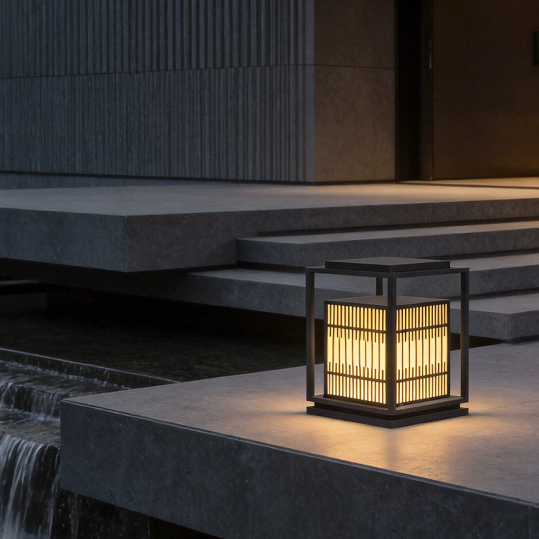 Bollard path lights illuminating a modern outdoor staircase with warm directional glow.