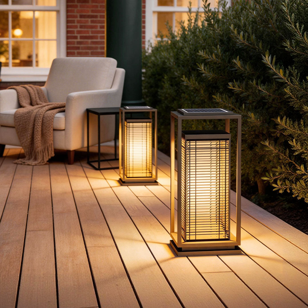Bollard pathway lighting with a modern design, illuminating a wooden deck beside a cozy seating area.
