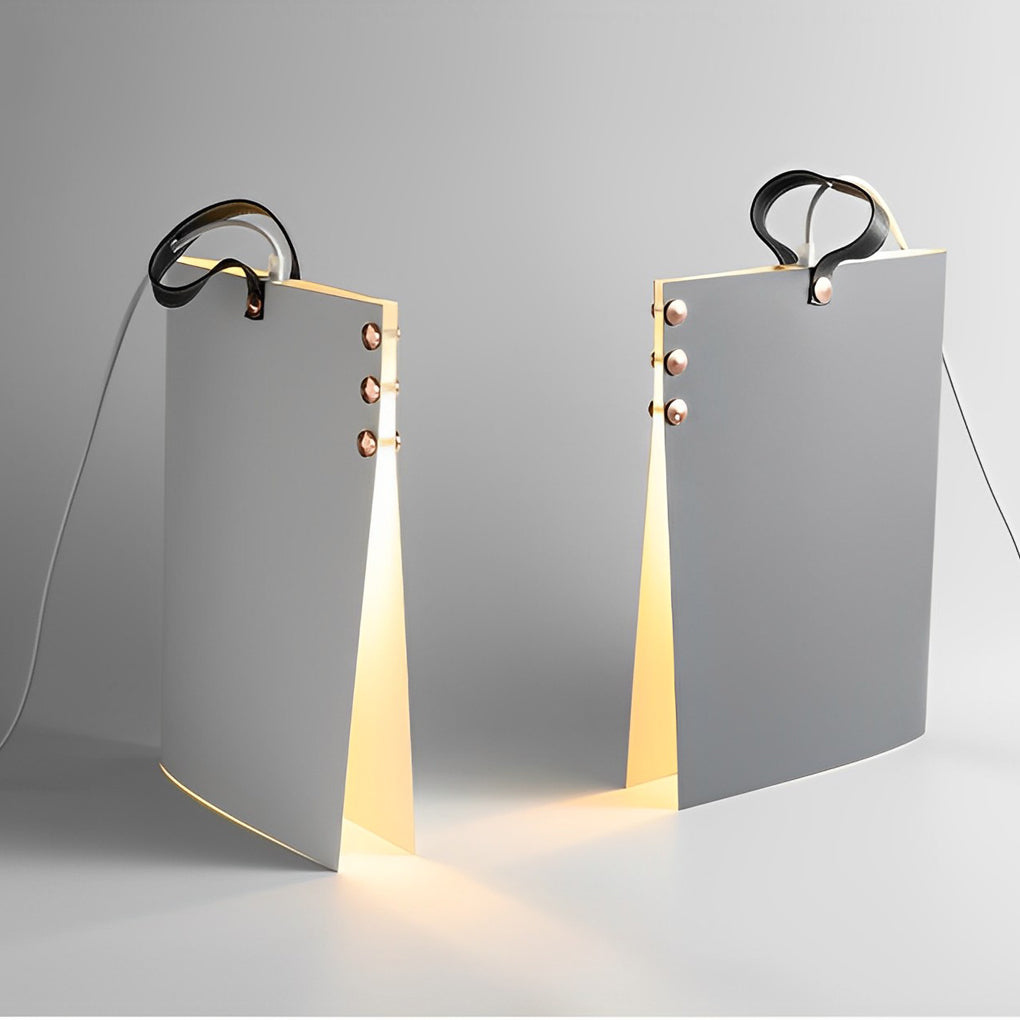 Detailed view of book pendant light with metal hook and layered book-like shade design, softly illuminated.