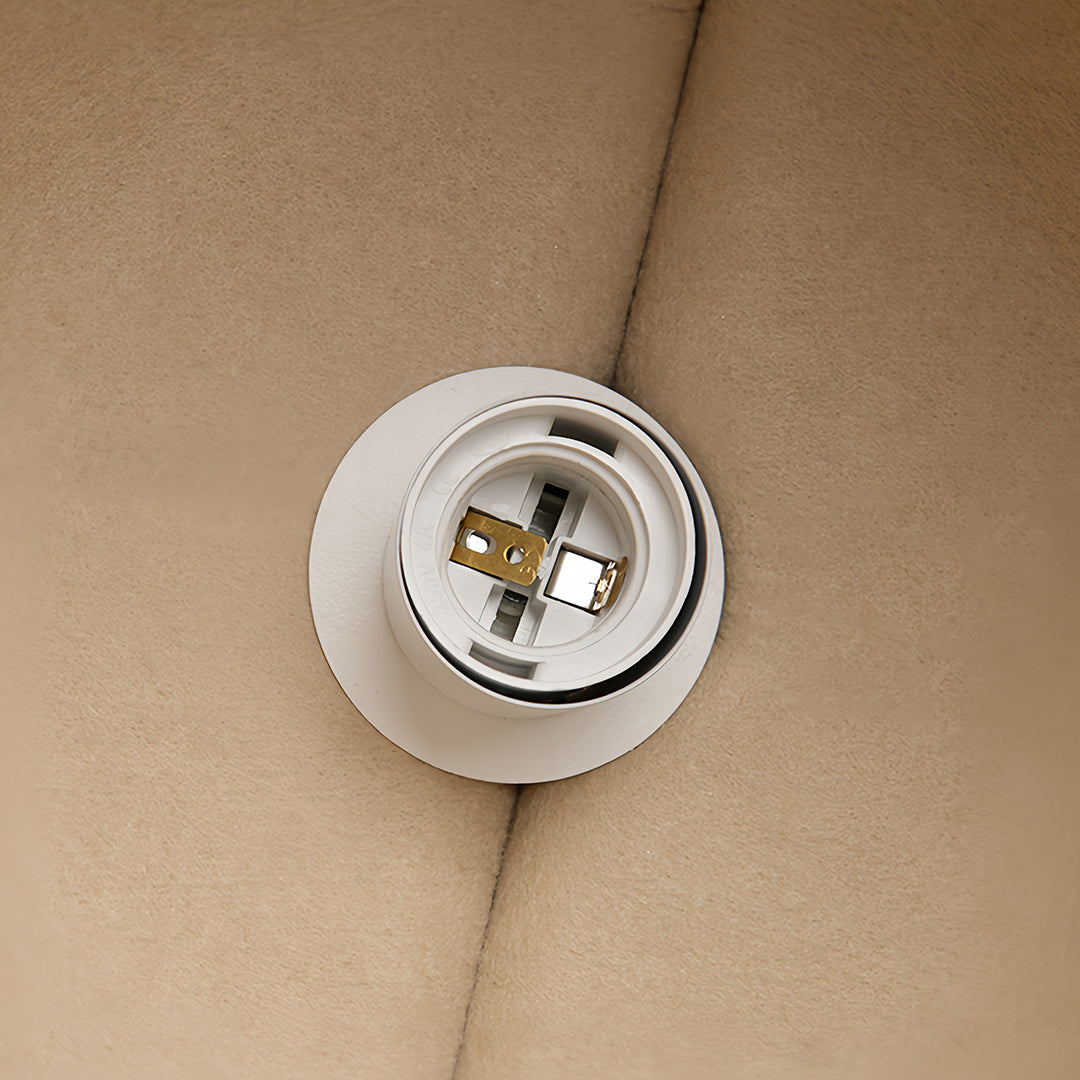 Bottom-up view of the white bulb socket and internal fitting for an adjustable pendant light fixture.