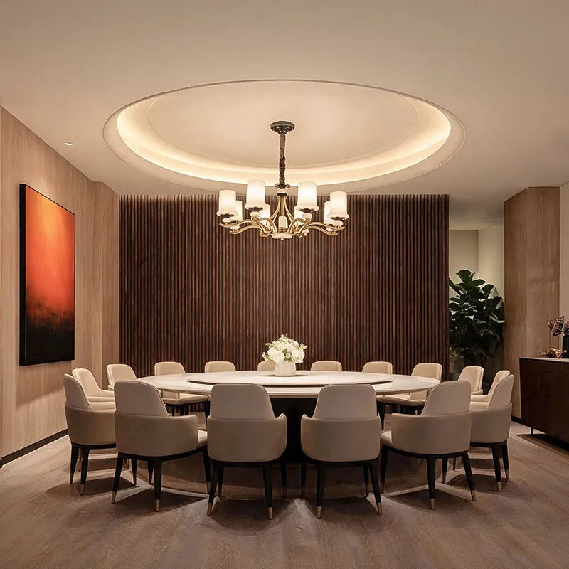 Brass candle chandelier installed in a contemporary dining space with a warm decorative glow.