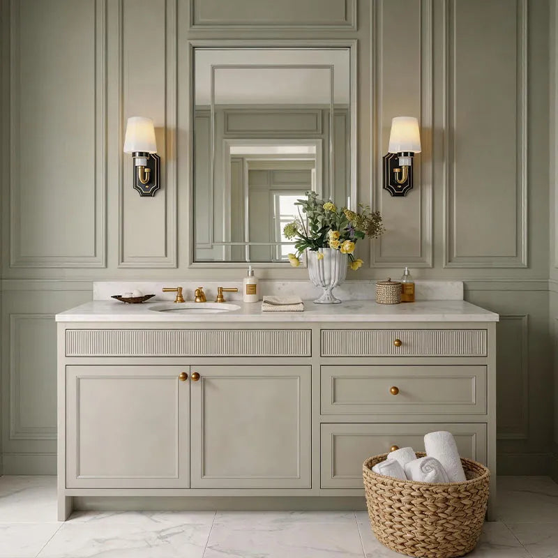 Brass candle sconces wall installed above a bathroom vanity with classic gold accents.