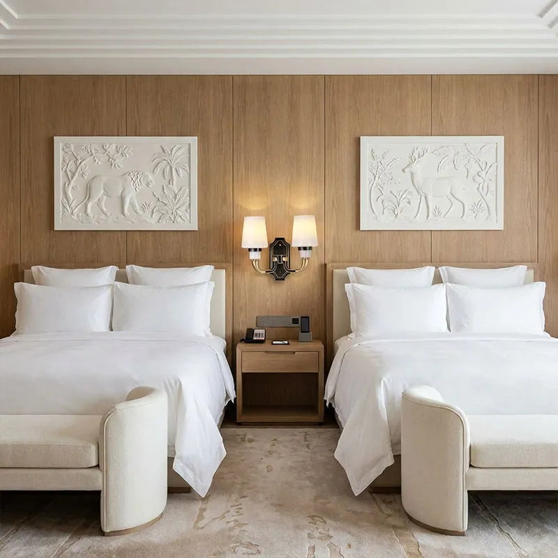 Brass candle sconces wall mounted beside beds with classic shades and decorative design.