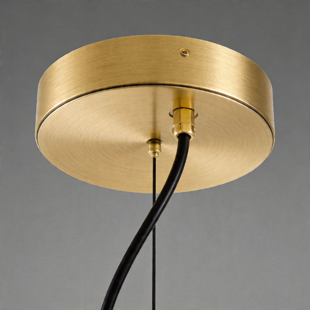 Detailed view of brass ceiling canopy and wiring for stained glass chandelier fixture.