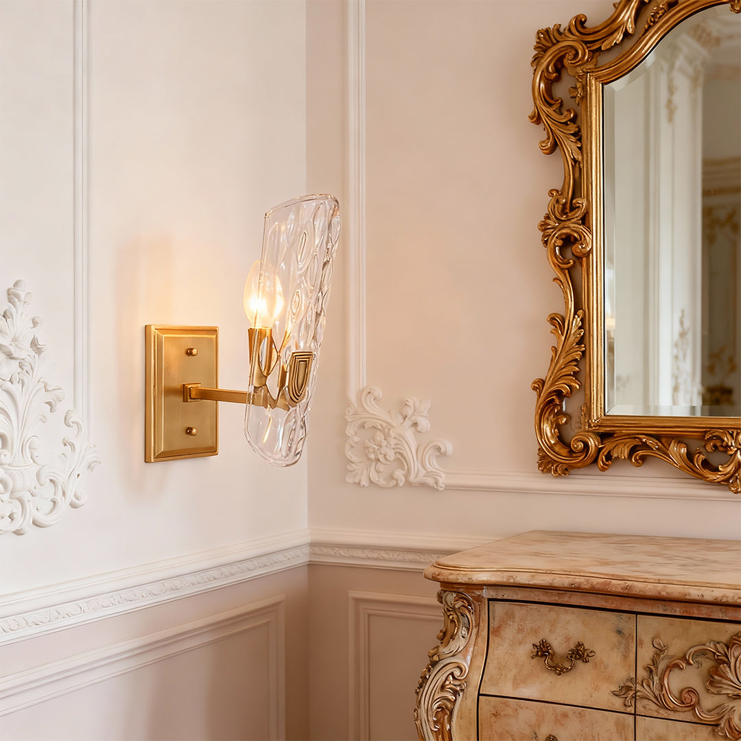 Modern luxury chandeliers style brass glass wall light beside ornate gold-framed mirror