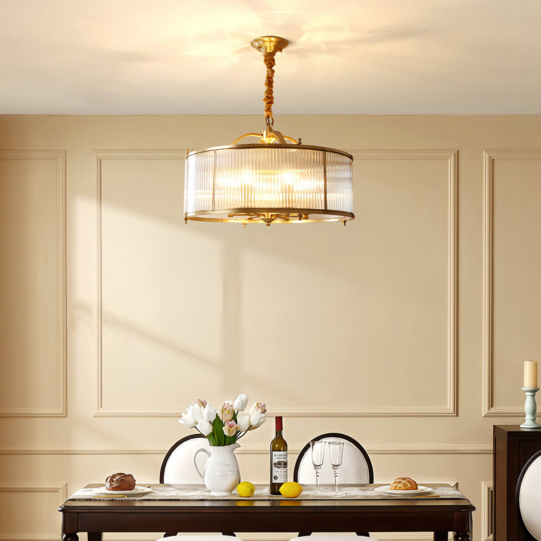 Brass semi flush mount ceiling light illuminating classic bedroom with cream wall paneling and dresser