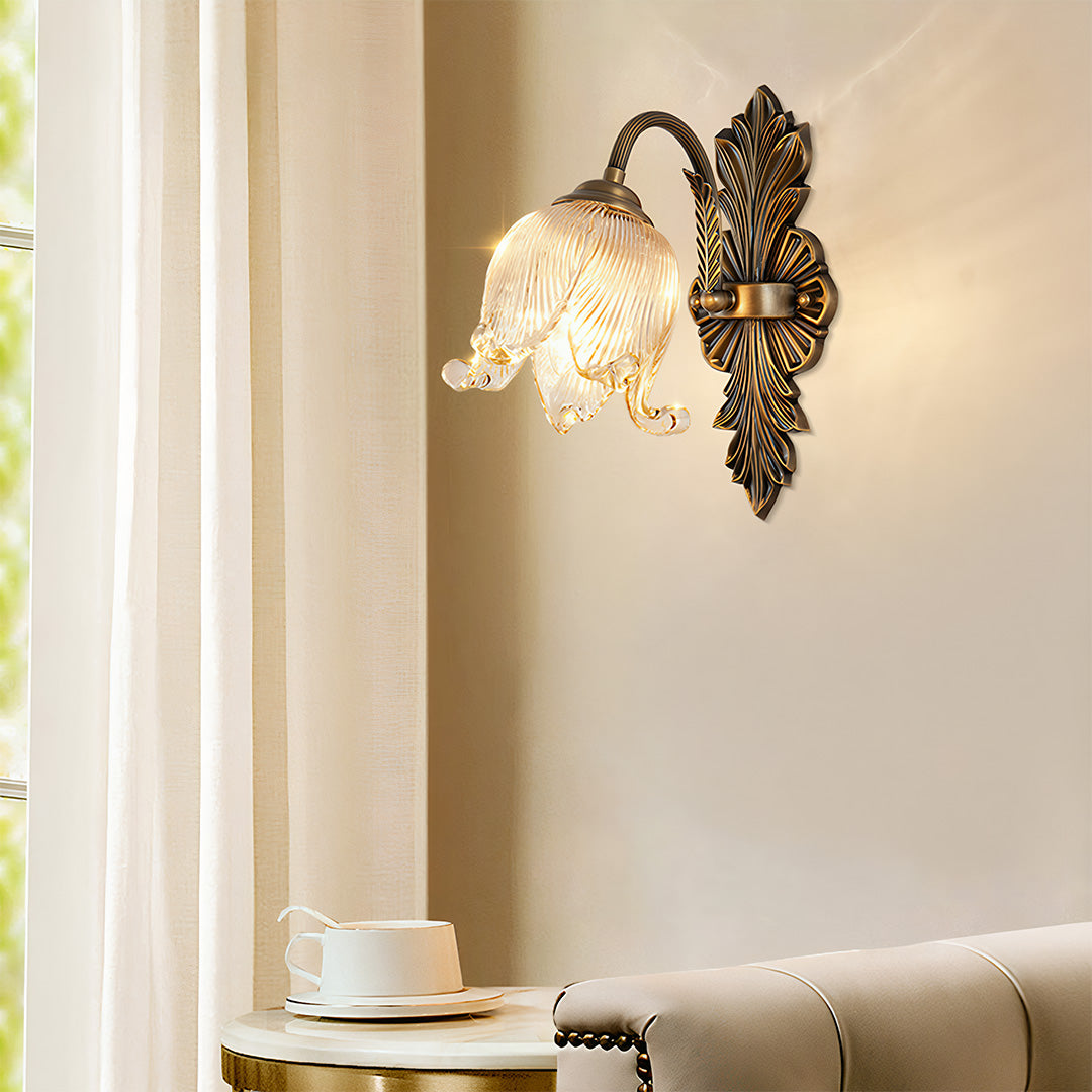 Brass wall lights creating warm glow in cozy bedroom with wooden furniture and linen curtains