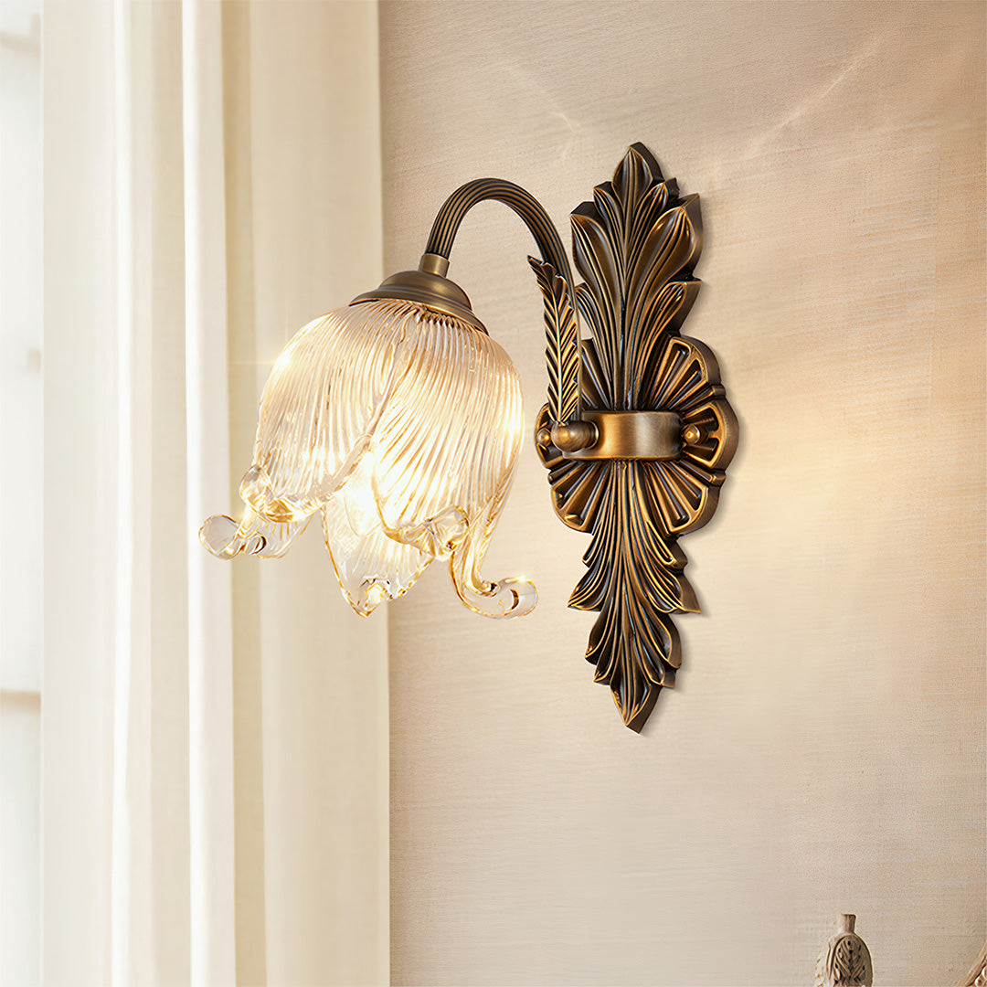 Brass wall lights mounted on cream wall creating warm ambient lighting with decorative fixture
