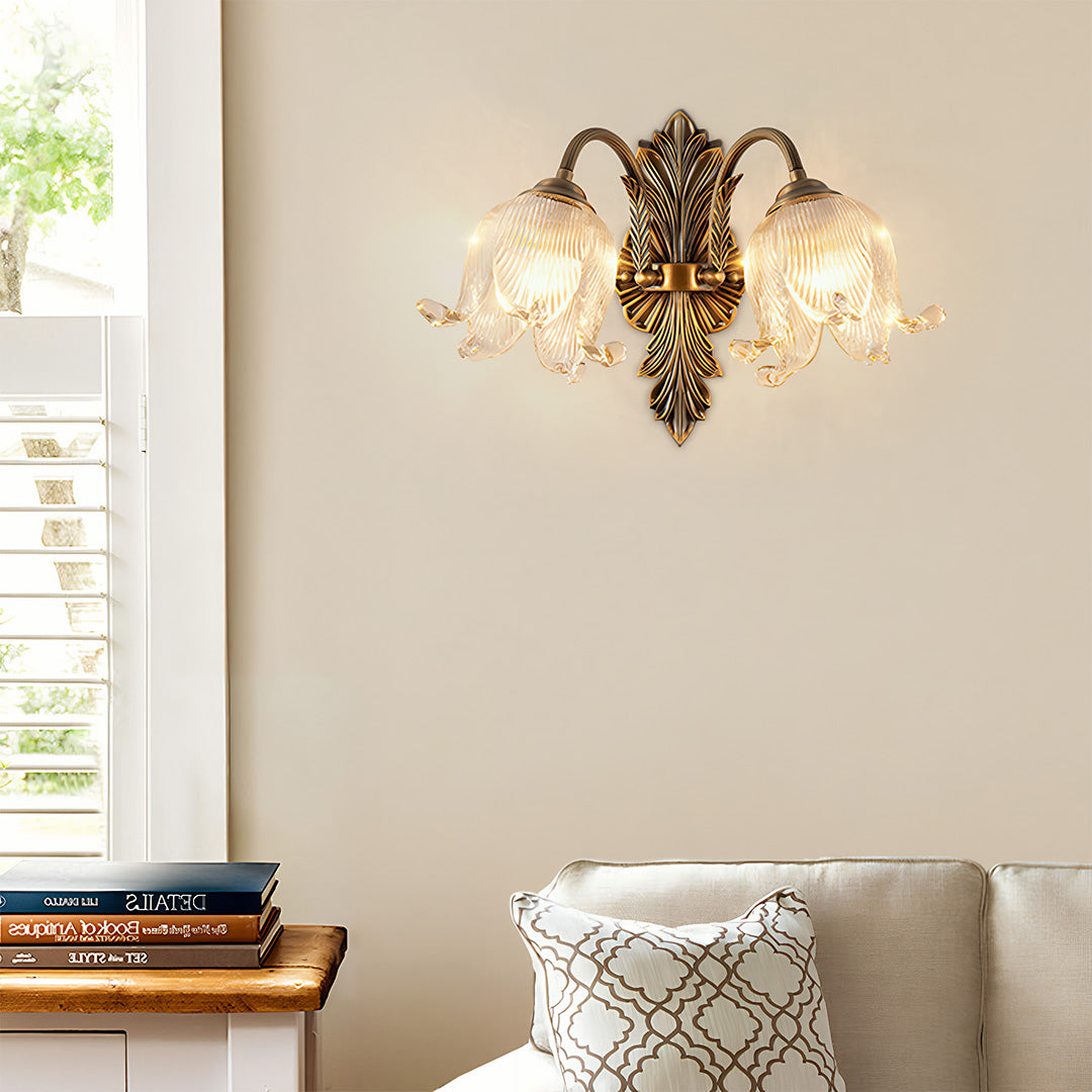 Brass wall lights illuminating modern living room with beige sofa and decorative pillows