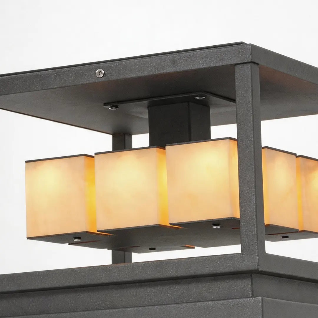 Brick pillar solar lights with a black square frame and warm translucent panels shown from the side.