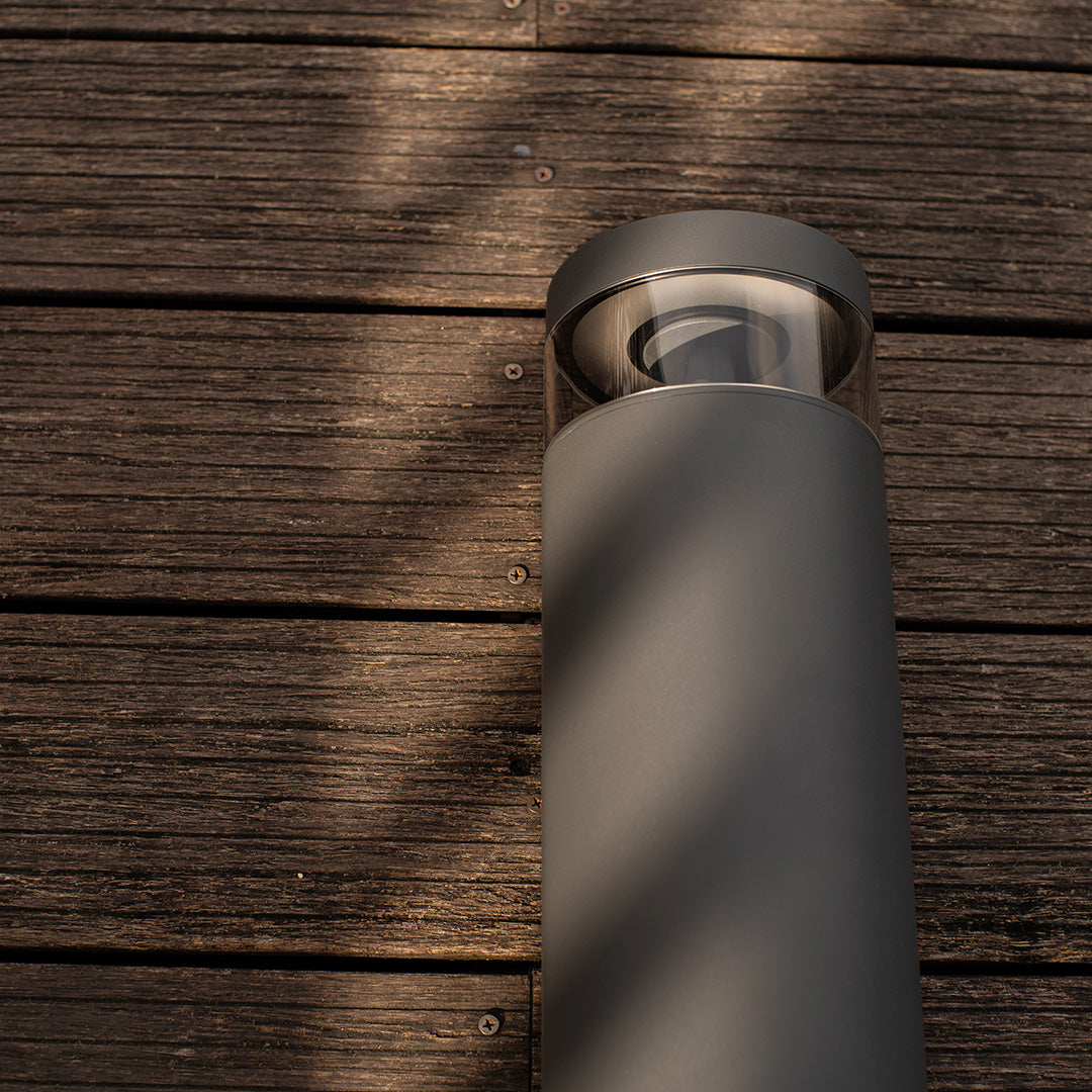 Contemporary pathway light outdoor fixture mounted on textured brick surface providing directional illumination