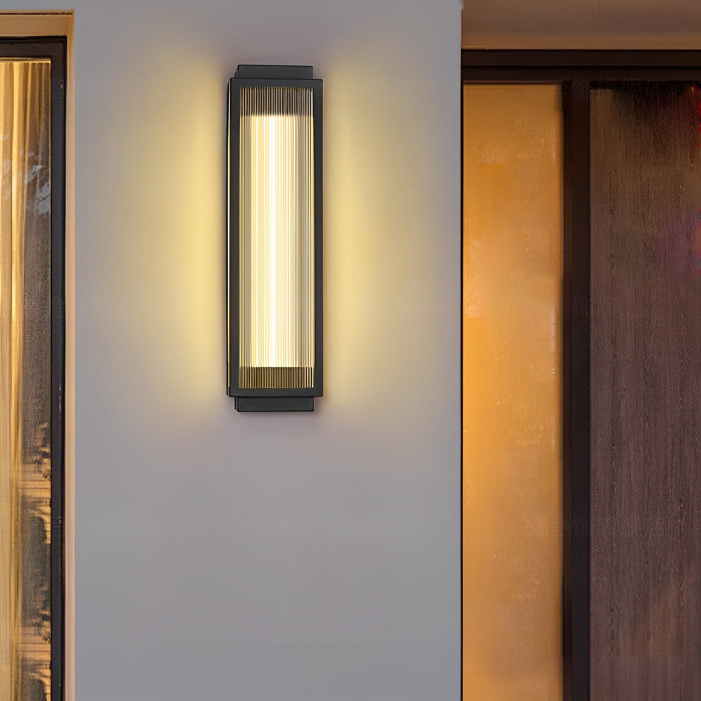 Bright reeded glass light illuminating a wooden panel wall, creating a cozy and stylish outdoor space.