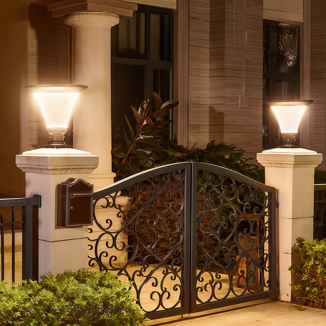 Bright solar garden light pillar casting light in a garden pathway.