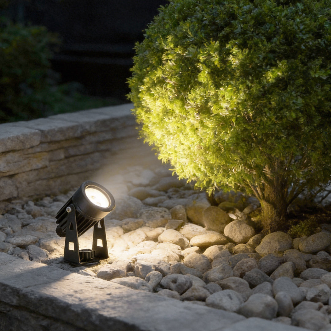 Bright solar powered landscape spotlights illuminating a garden pathway at night