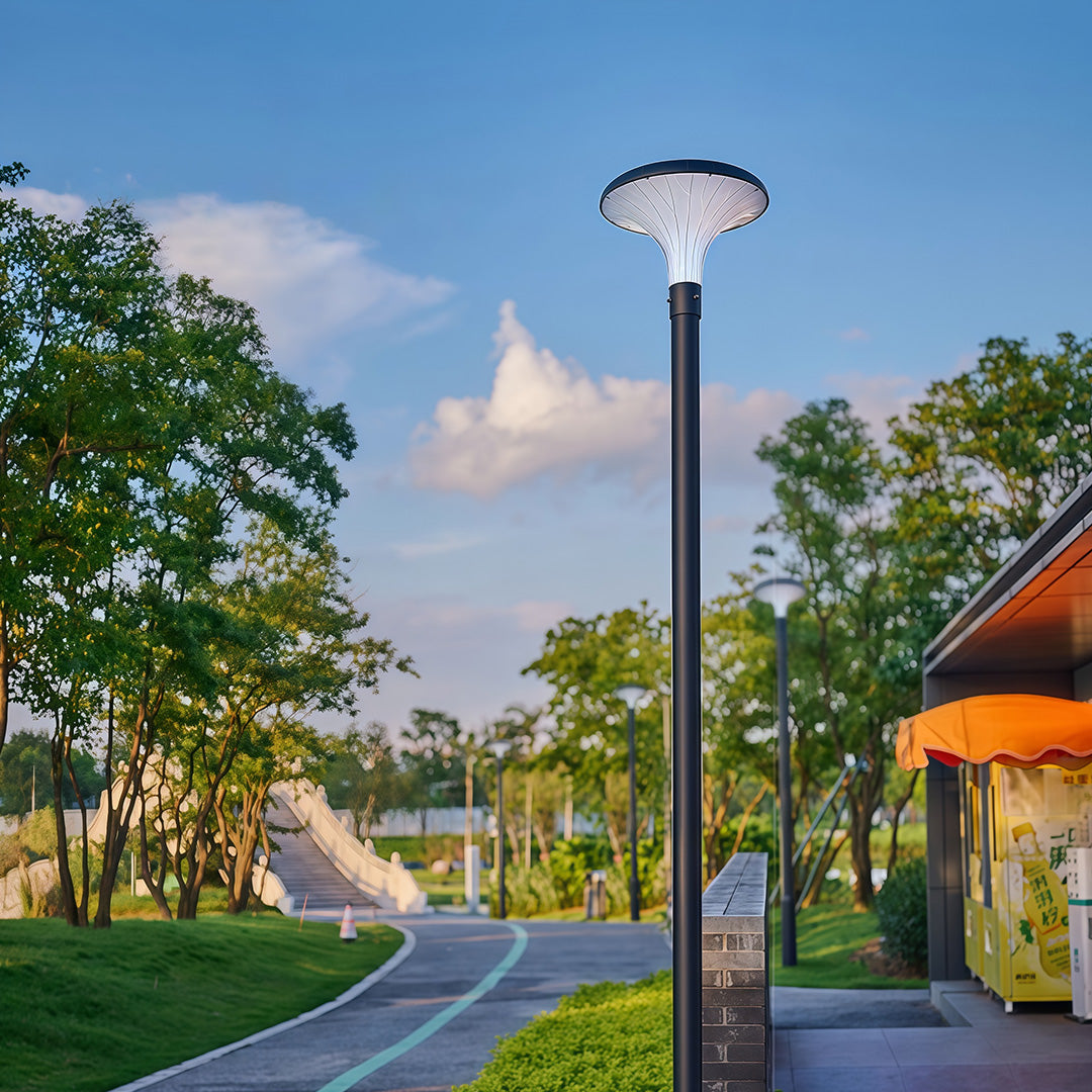 Bright street light on a pathway, creating a well-lit atmosphere in a modern neighborhood.