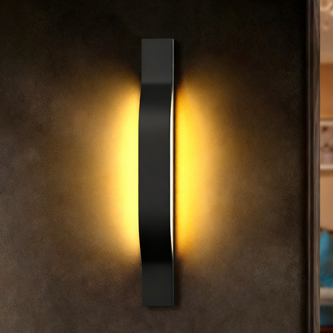 Bright vertical outdoor exterior wall lights casting warm ambient lighting on a textured wall surface.