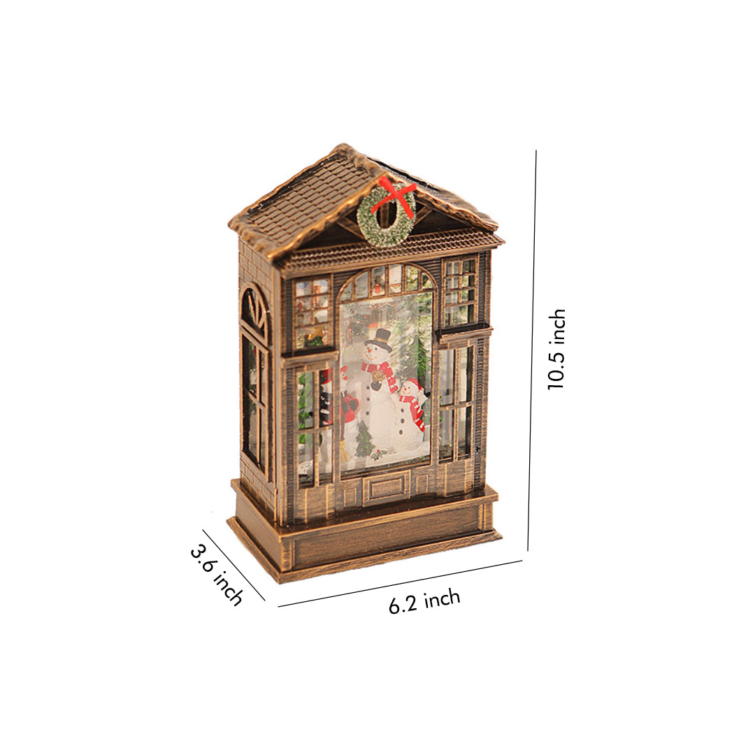 Vintage-style christmas decoration with light featuring a glowing festive scene inside a bronze lantern.