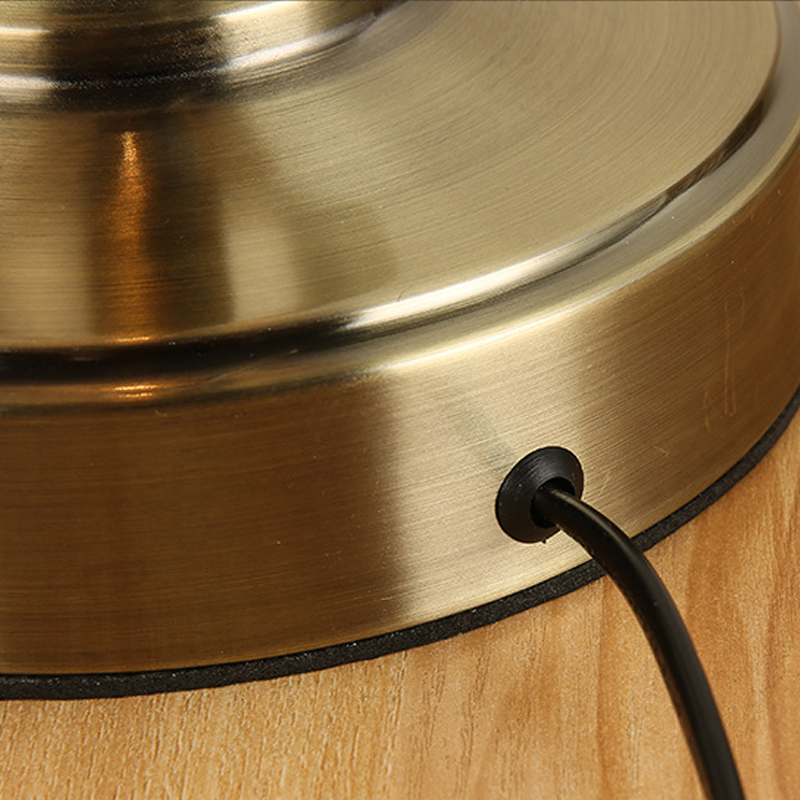 Bronze desk lamp base with power cord connection detail.