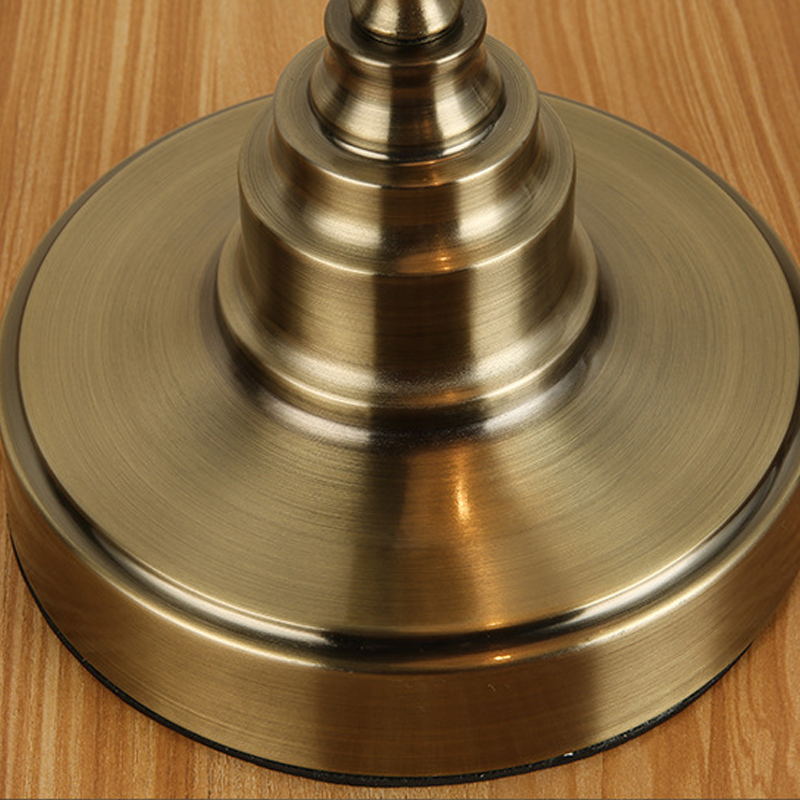 Bronze desk lamp weighted base showing stable construction.