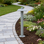 Bronze aluminum path lights creating a warm glow along a curved nighttime garden pathway.