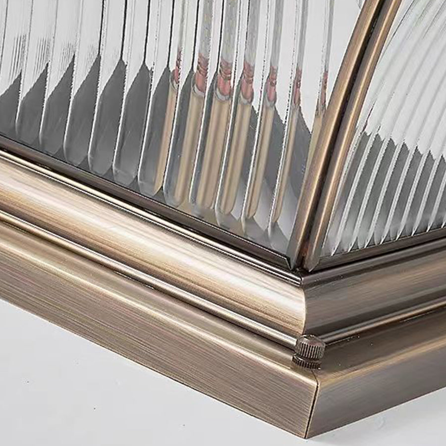 Detailed view of bronze lamp corner construction showing precision metalwork and assembly joints