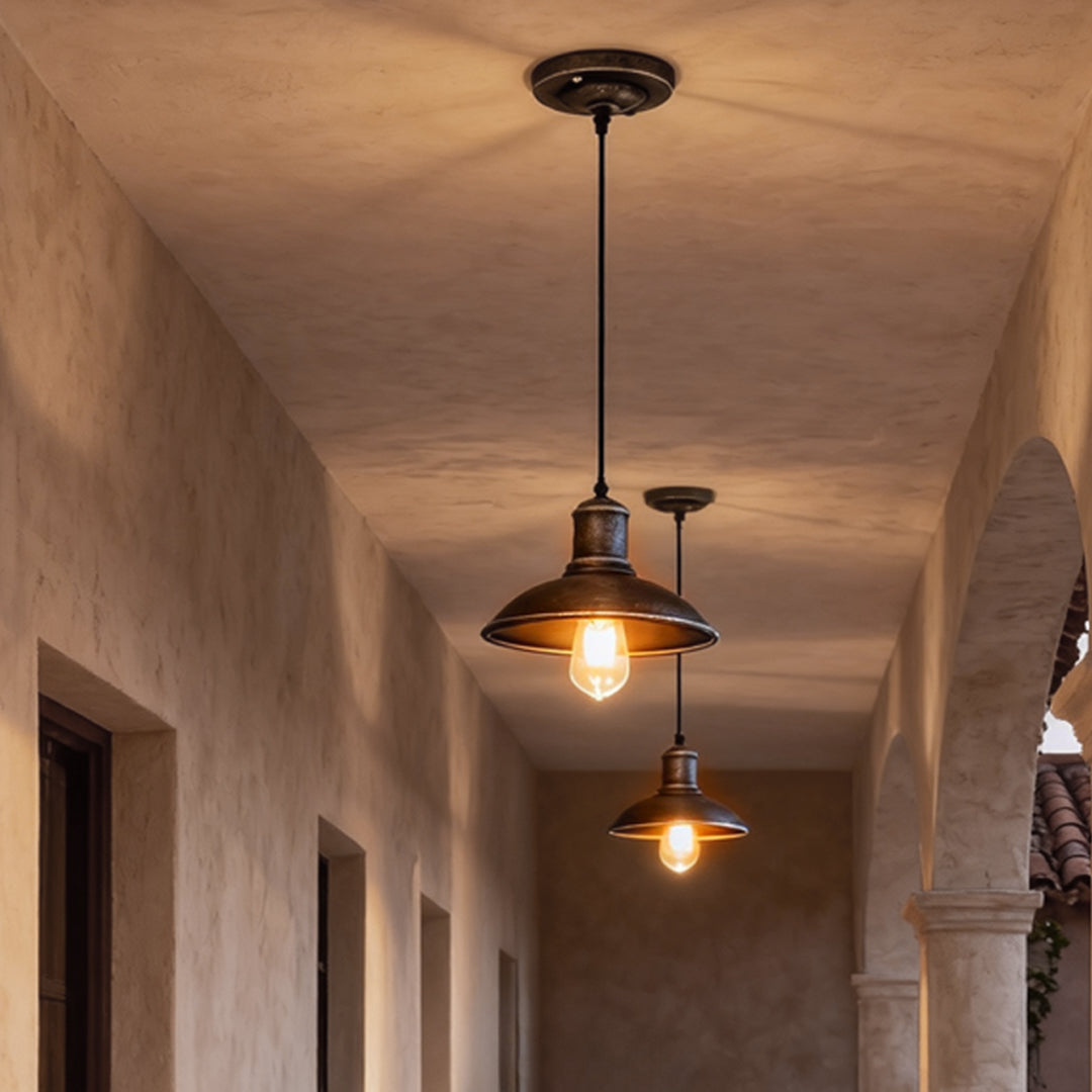 Bronze pendant lighting illuminating a hallway, adding warmth and vintage charm to the space.