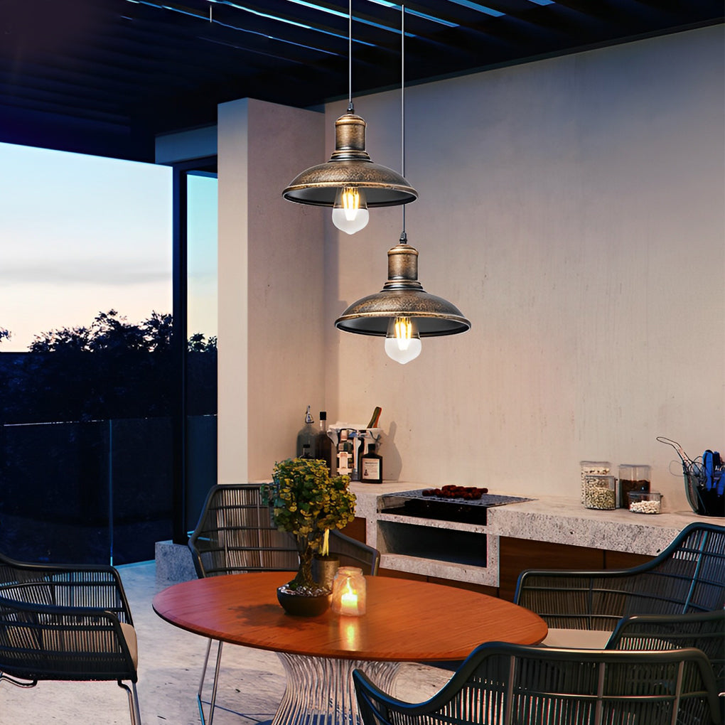 Bronze pendant lighting fixture under a wooden roof, creating a warm and inviting outdoor ambiance.