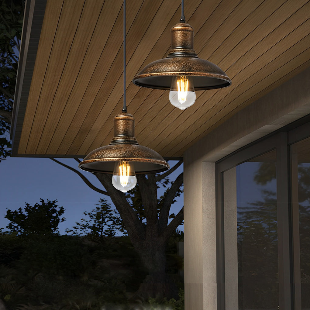 Bronze pendant lighting hanging above a wooden table, perfect for outdoor dining and gatherings.