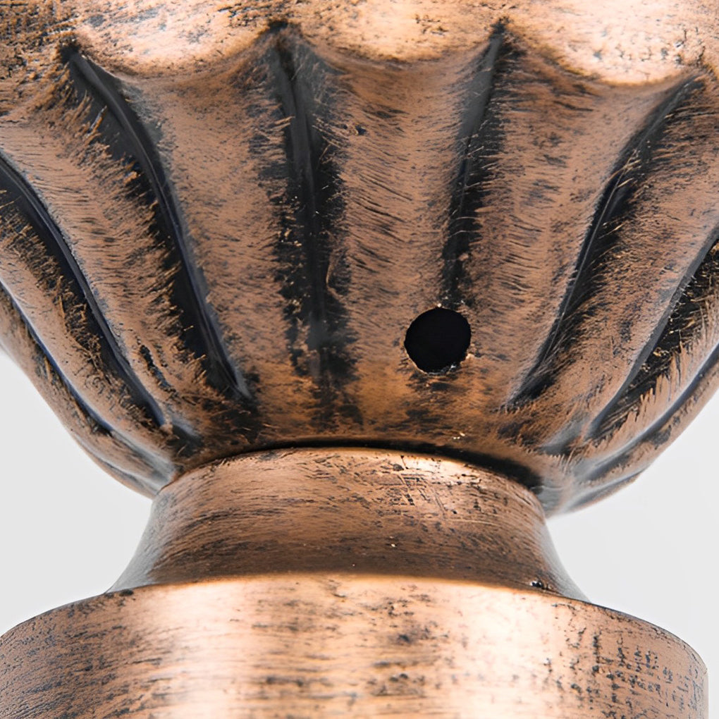 Bronze street lamp with detailed view of its decorative structure.