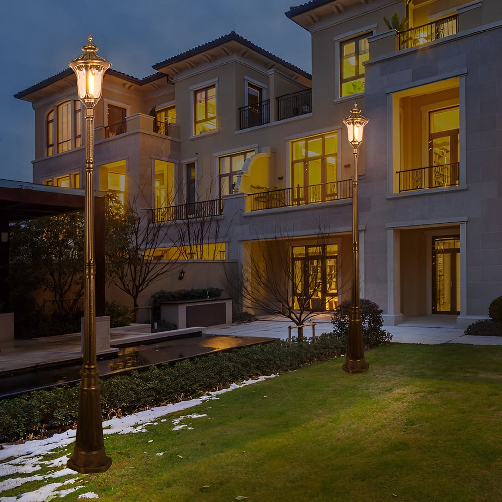 Bronze street lamp illuminating a minimalist outdoor entrance with focused glow.