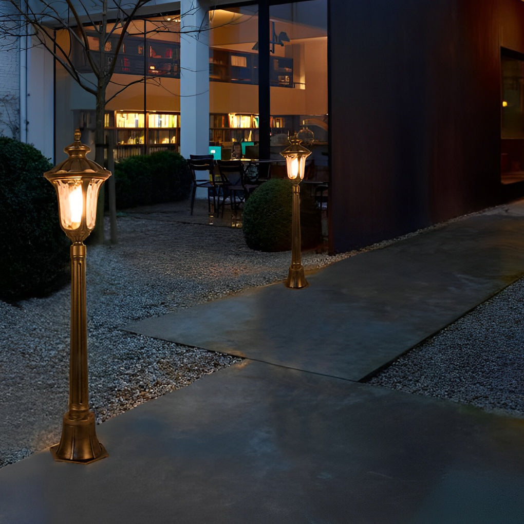 Bronze street lamp enhancing a modern outdoor seating area with warm light.