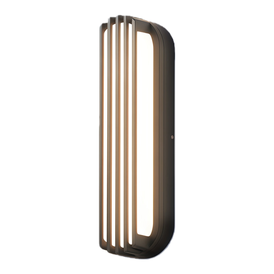 Vertical bronze wall-mounted linear lighting shown in a warm outdoor pathway scene attached to a modern fence.
