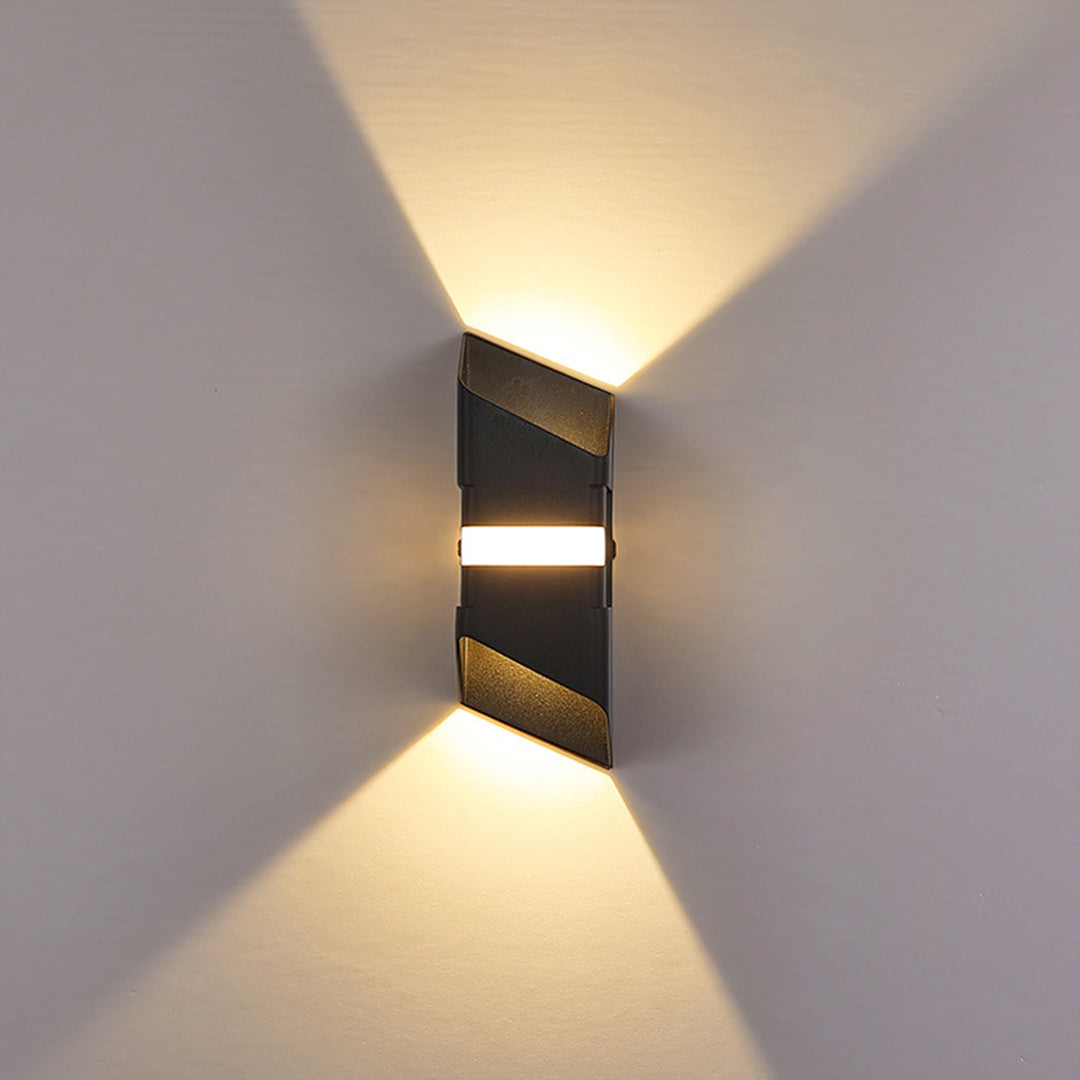 Dark bronze wall sconce with horizontal light bands creating contemporary lighting effect