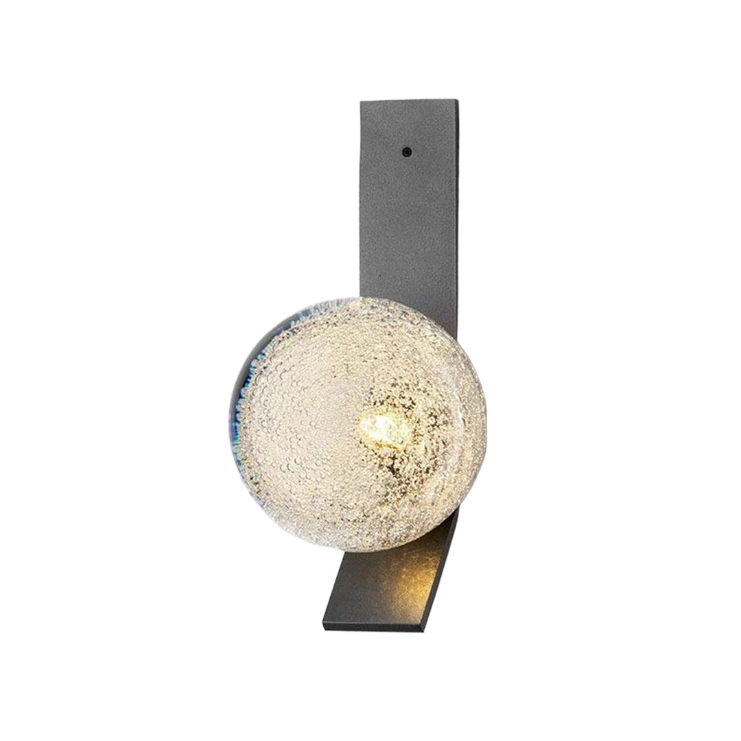 Dark bronze wall sconce with textured glass globe creating sophisticated accent lighting