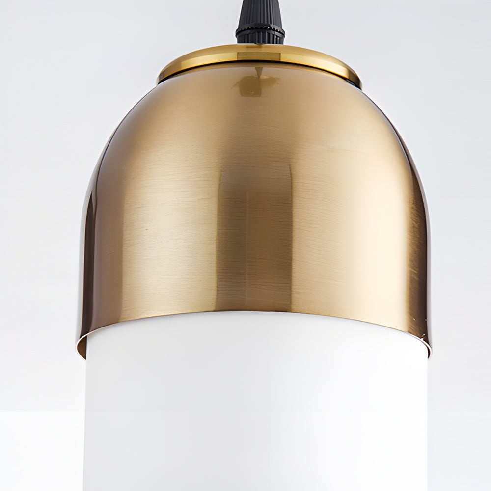 Close macro detail of brushed gold hardware on a Gold Frosted Cylinder Pendant light fixture.