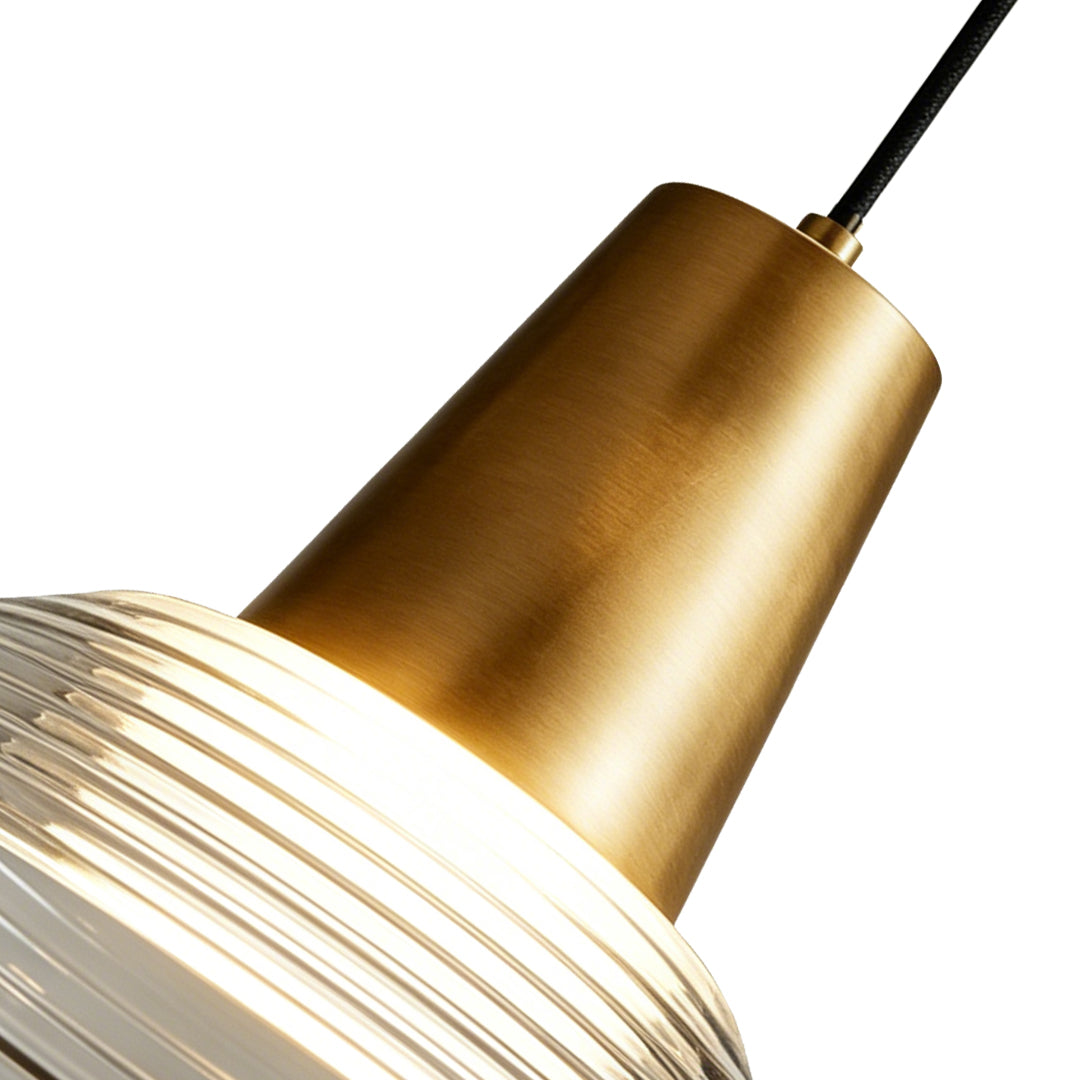 Close up detail of the brushed gold top on a modern glass cone pendant light with ribbed shade.